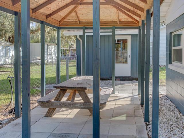Covered patio with a workshop with electric and water.