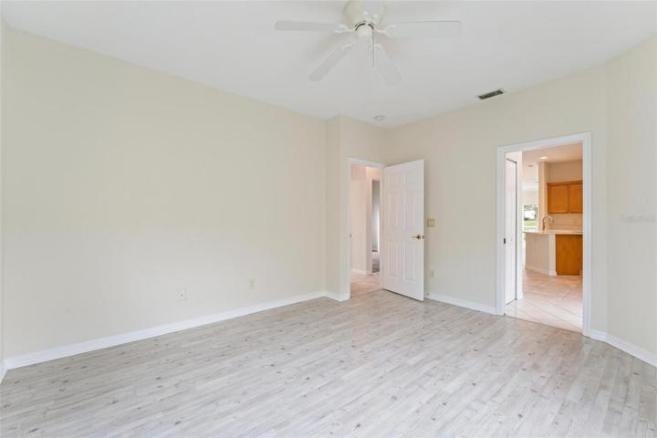 VIEW of BONUS ROOM with SWING DOOR to HALLWAY AND BATH. Bonus Room also features a second door, a sliding door, providing access to the kitchen.