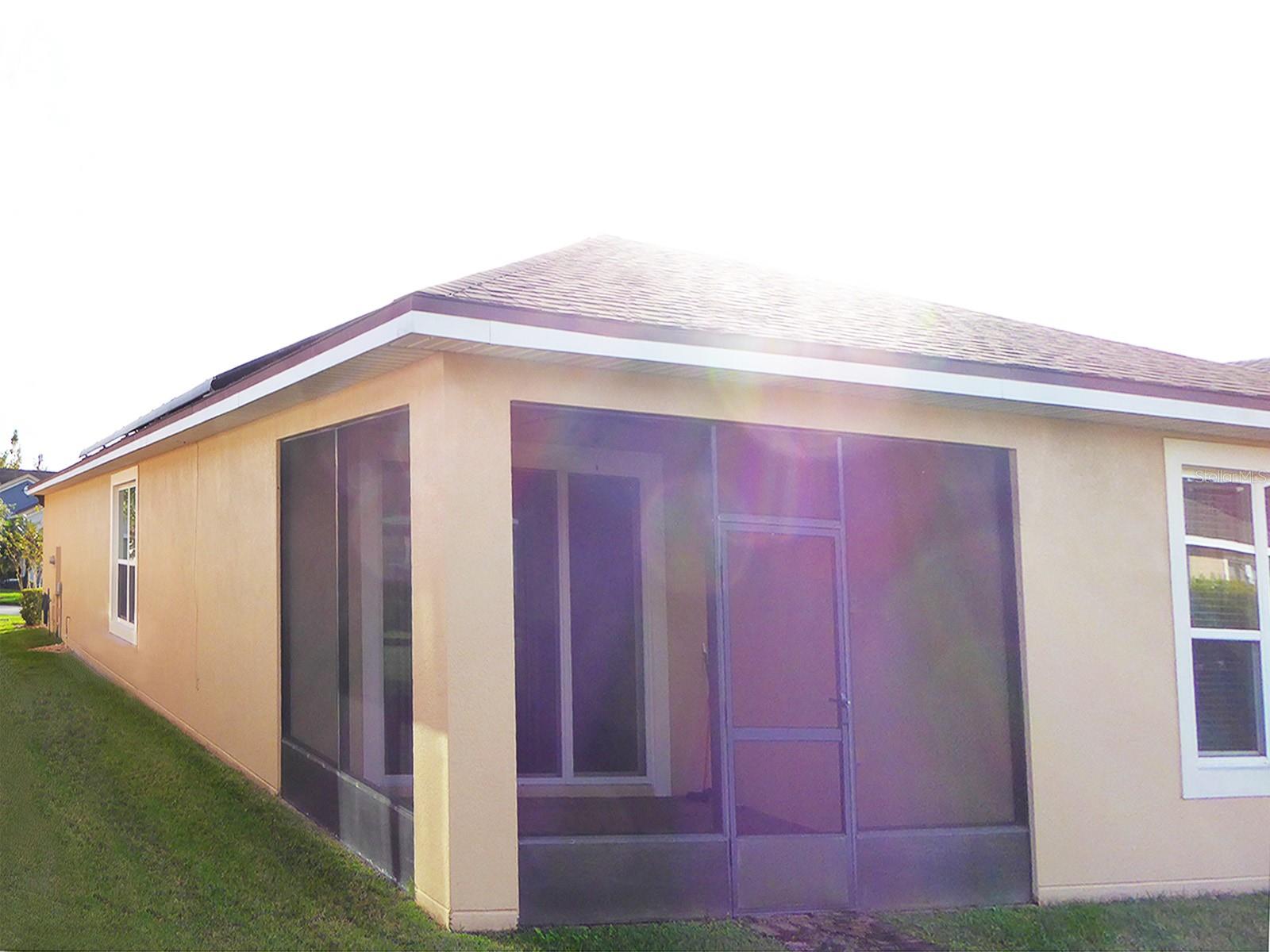 Back of house side with solar panels and lanai