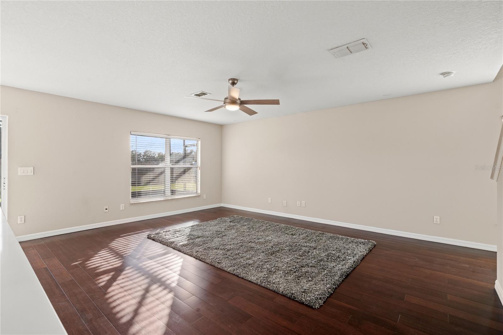 Family Room with solid wood flooring offers a bright and open space to enjoy.