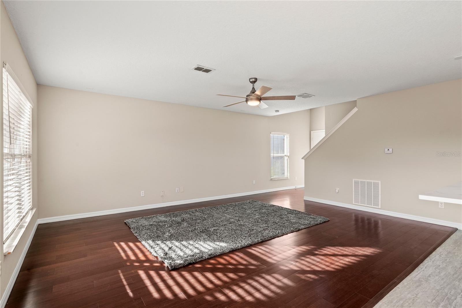 Family Room with solid wood flooring offers a bright and open space to enjoy.