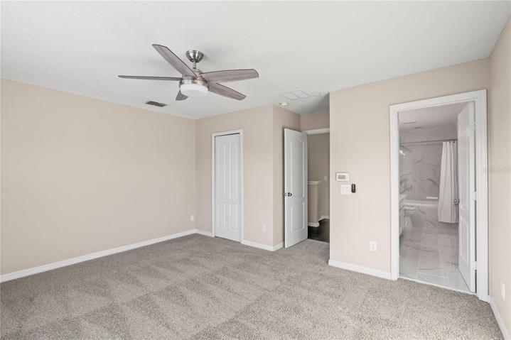 Master bedroom includes a walk-in closet, contemporary lighting and fresh carpeting