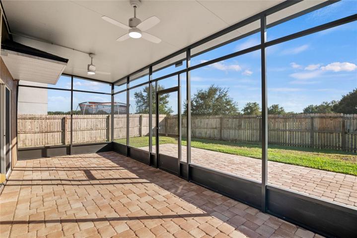 Covered and screen enclosed brick paver patio with newly installed modern fans. Enjoy Florida living year round!