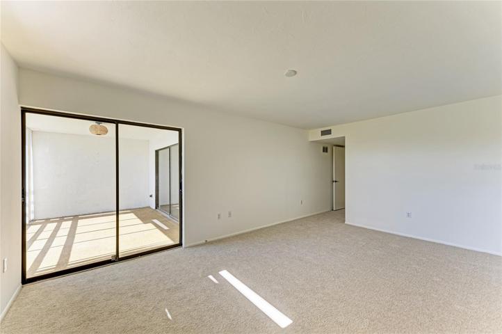 Master bedroom w new carpet, paint, and removed popcorn ceiling.