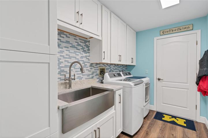 Inside Laundry Room with Solid Wood Cabinetry & Large SS Farm Sink/Tiled Backsplash/Updated Washer/Dryer