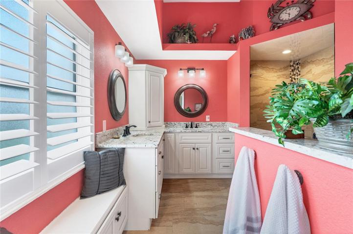 Master Bathroom with Solid Wood Cabinetry and Bench with Plantation Shutters