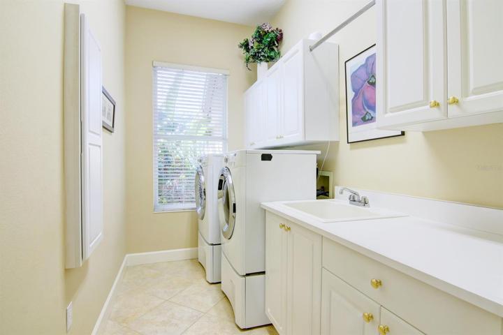 Laundry room with sink and storage