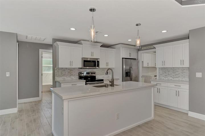Complete, Efficient Kitchen. Second and Third Bedrooms behind.