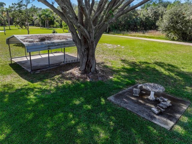 DRONE VIEW OF OPEN PATIO AND DOUBLE CARPORT