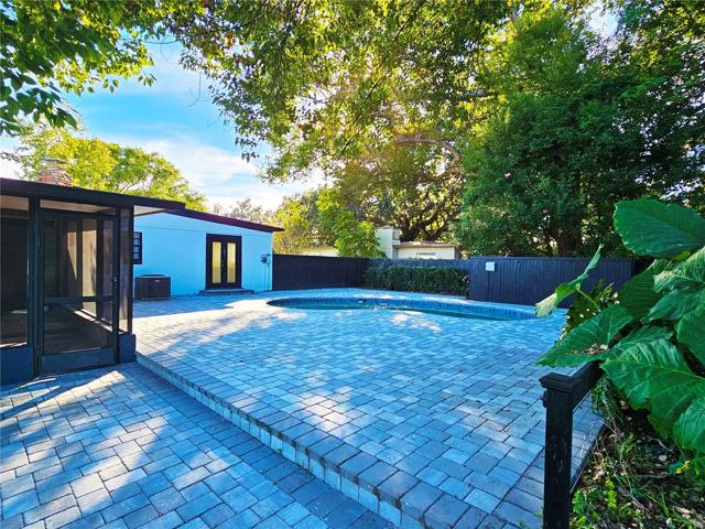 View of paver pool deck &amp; screen enclosed patio