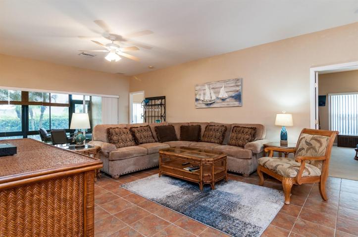 The triple slider in the living room leads to the enclosed and covered lanai.