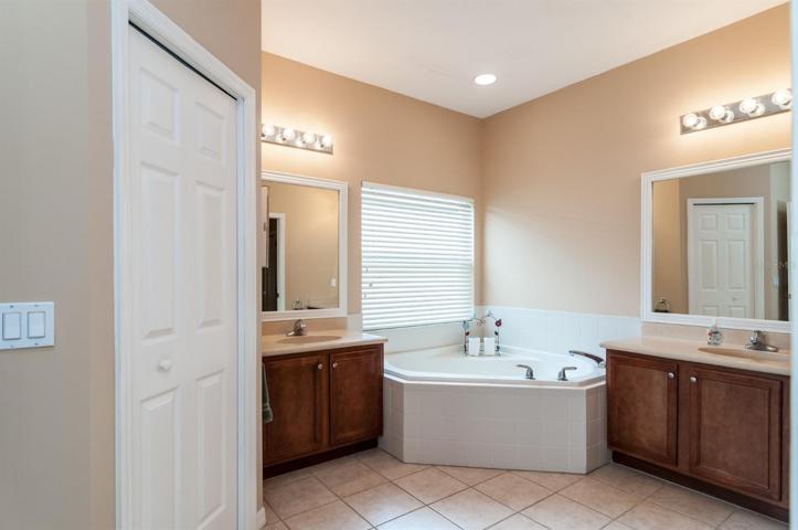 The master bath 2 vanities, corner garden tub, 2 walk in closets and a stall shower.