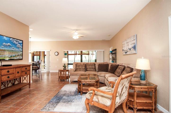 The living room has ceramic tile and ceiling fan with light.