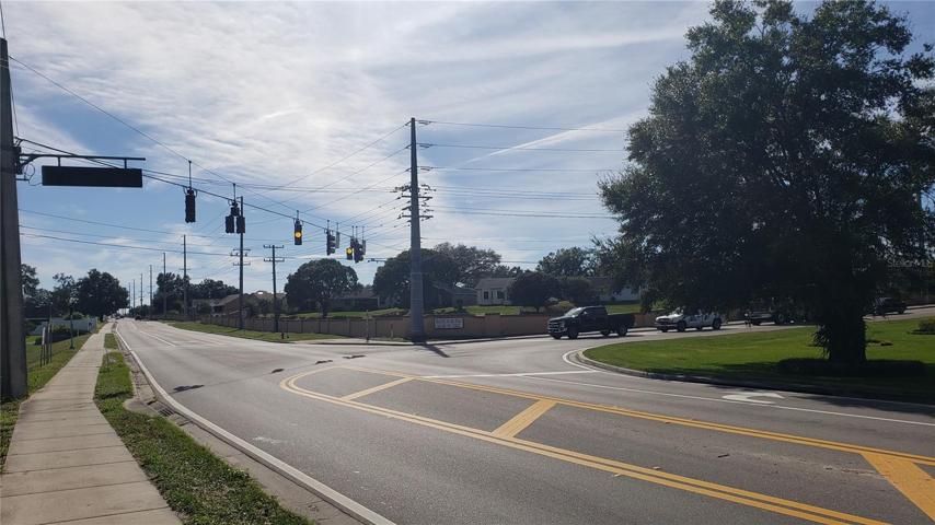 Old Polk City Road turns right at traffic signal.   Walt Williams Road goes straight.  Property is to the left of foreground