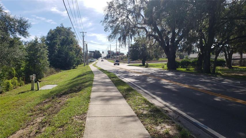 Looking South on Old Polk City Road at Intersection of Walt Williams and Old Polk City Road to the right at traffic light
