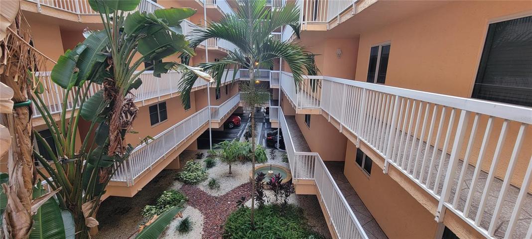 Inside you'll find the landscaped atrium and the condo is to the left