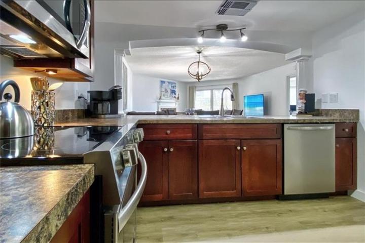 View from kitchen extends through dining, living, deck and outdoor spaces beyond