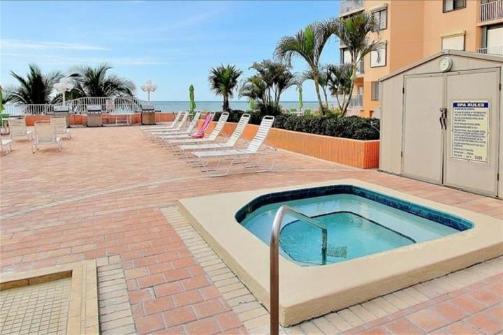 Spa right next to the pool, stairs from the pool deck down to the parking area and direct beach access