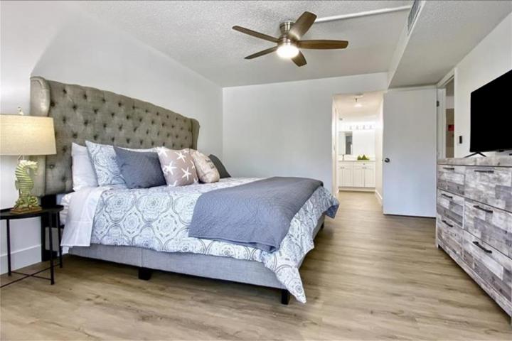 Primary bedroom with king bed and workspace