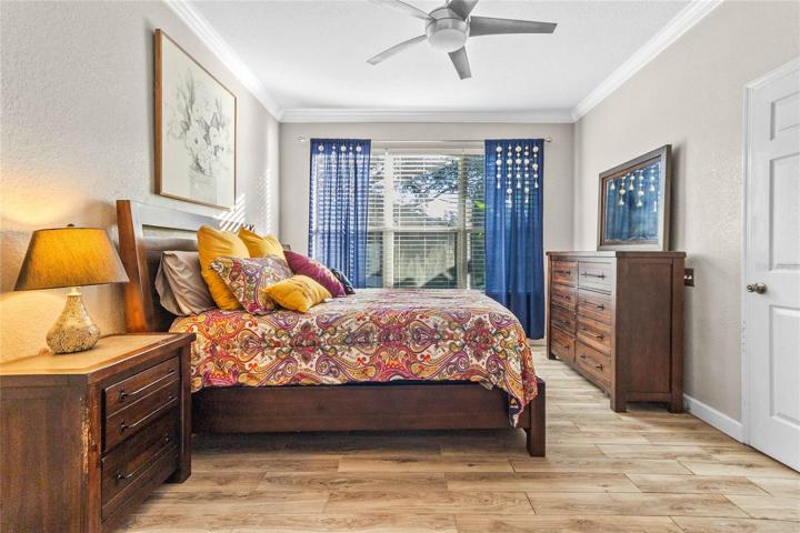 Crown molding, a view of the backyard, and a large walk-in closet enhance the appeal.