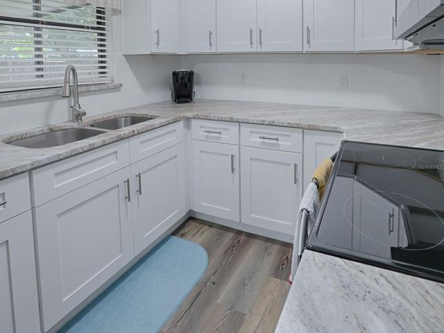 Completely updated Kitchen featuring 36" Shaker, Soft Close Cabinets with Crown Moulding, Granite Countertops, Stainless Appliances, Custom Subway Tile Backsplash and Luxury Vinyl Plank Flooring.