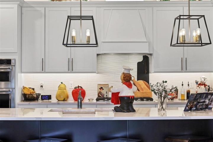 Center kitchen island is over-sized and has cabinets on each end