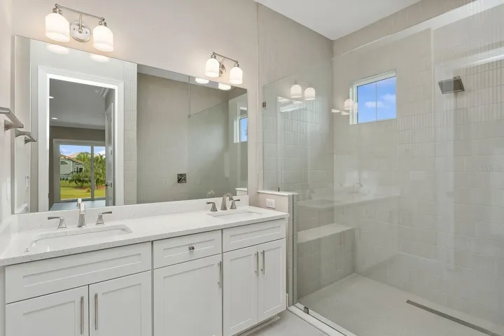 Guest bath w/doorless shower entry and free standing rimless glass enclosure