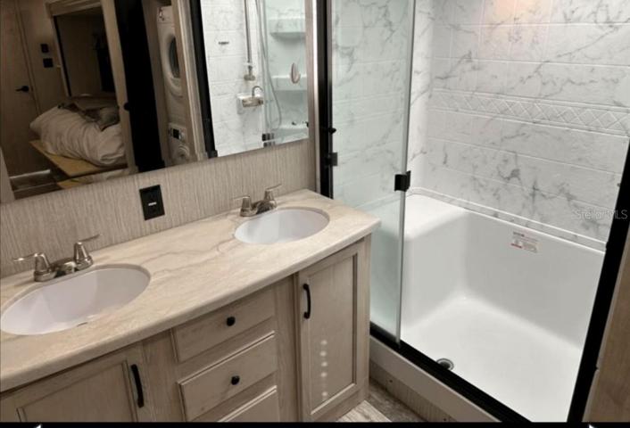 5th wheel bathroom has dual sinks and full size shower stall.