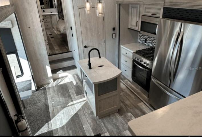 5th wheel kitchen has lots of counter space, and stainless steel appliances.