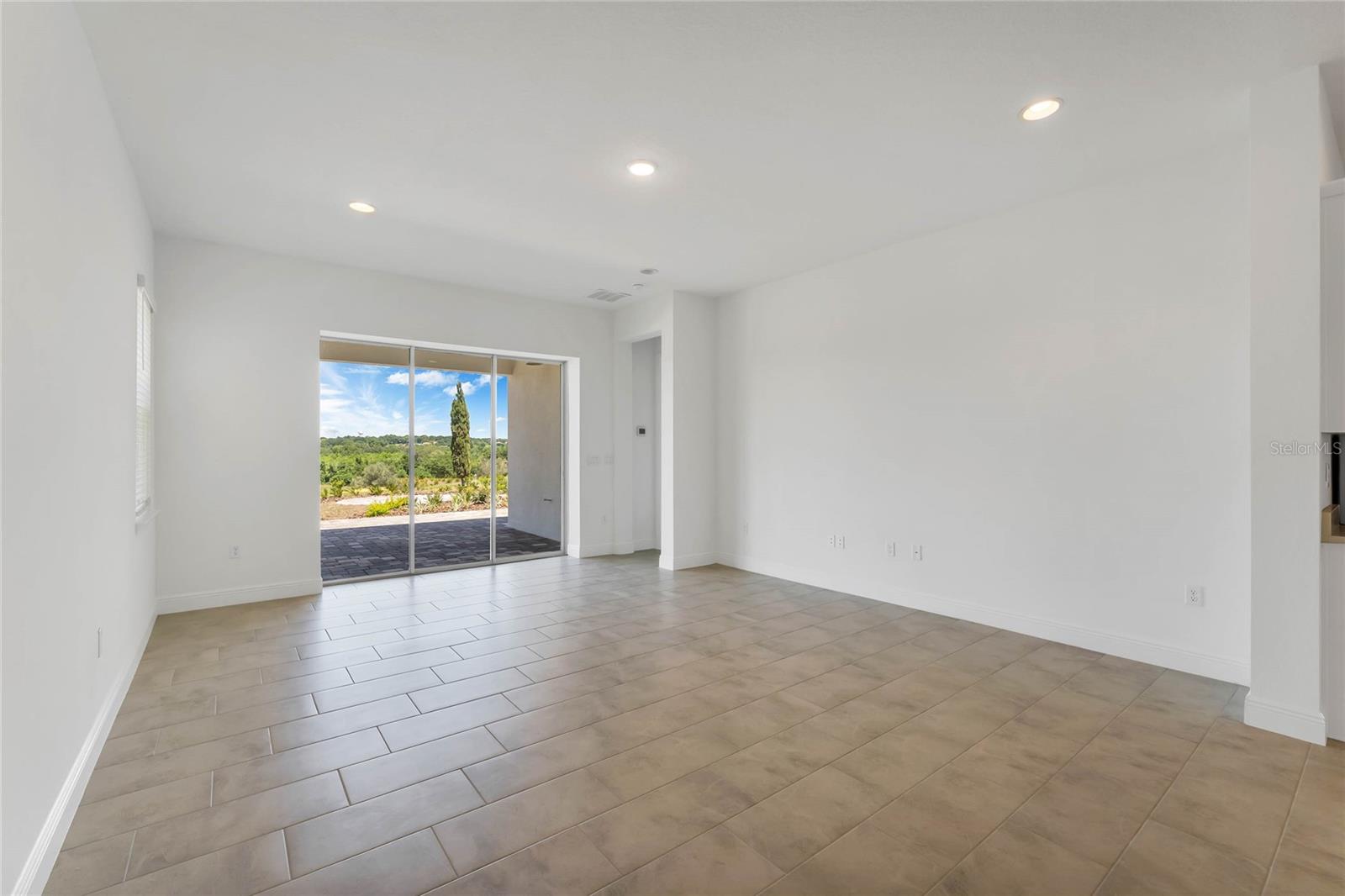 Open Living Room facing the pool and golf course. This picture was taken before pool being built.