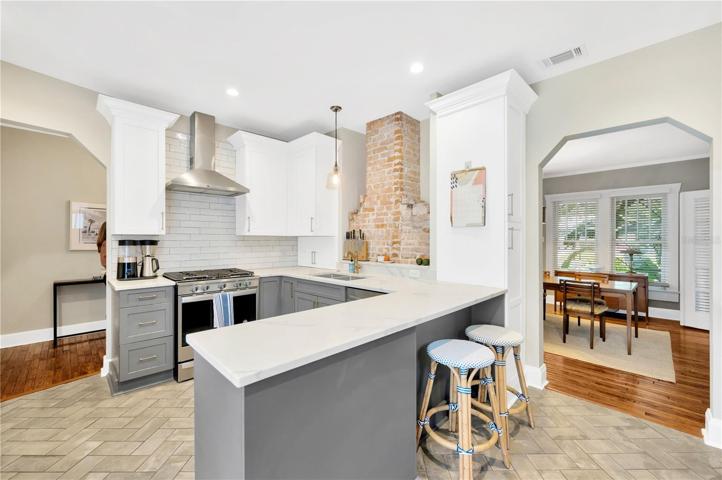 Exposed Brick From Fireplace Adds Warmth To The Kitchen!