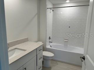 Shared bath with tub/shower and single sink.