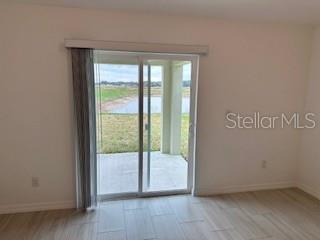 Sliders with vertical blinds to the back patio.