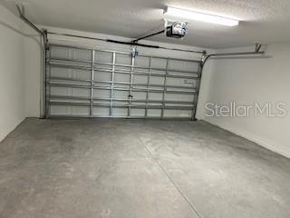 Garage interior with opener and remotes.