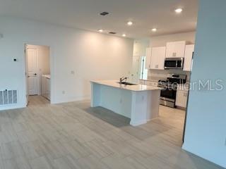 View from the family room to the kitchen and laundry.