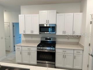 Staggered cabinets in the kitchen with plenty of counter space.