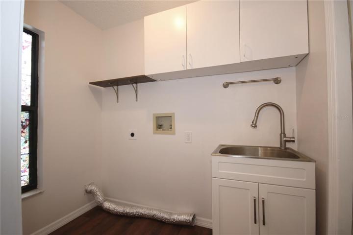 Inside laundry room with utility sink