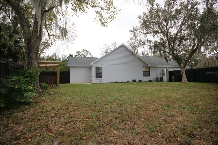 View of the back of the home and fenced in yard