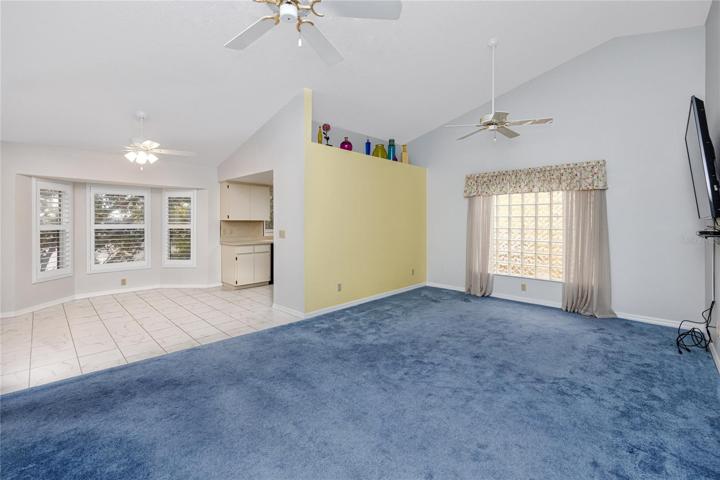 Spacious open living room with cathedral ceilings that leads into the dining/kitchen for easy entertaining!