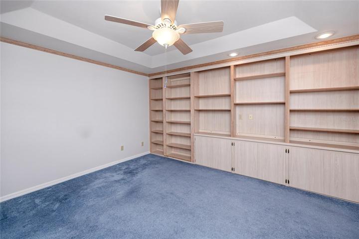 3rd bedroom with tray ceilings and built ins