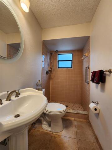Second bathroom, new toilet. Pedestal sink and walk in shower. This bathroom is convenient for guests and coming in from garage