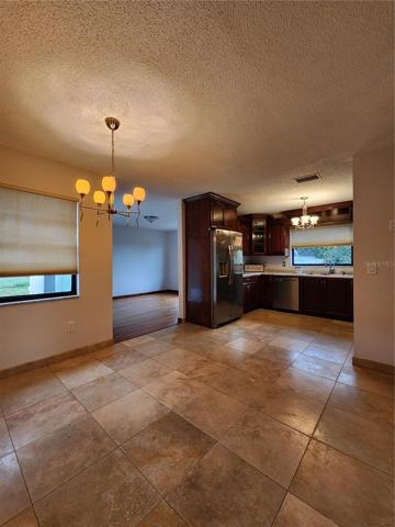 Breakfast nook and kitchen. Hardwood cherry cabinets! Lots of storage