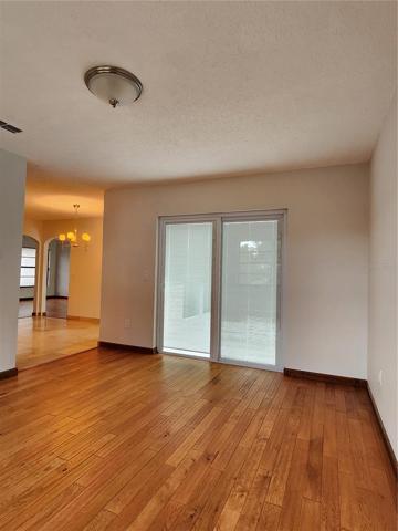 Family room features a new glass sliding door with built in blinds.