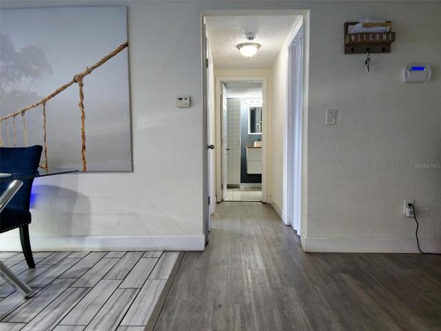 HALLWAY TO BEDROOM ONE, LAUNDRY ROOM AND GUEST BATH