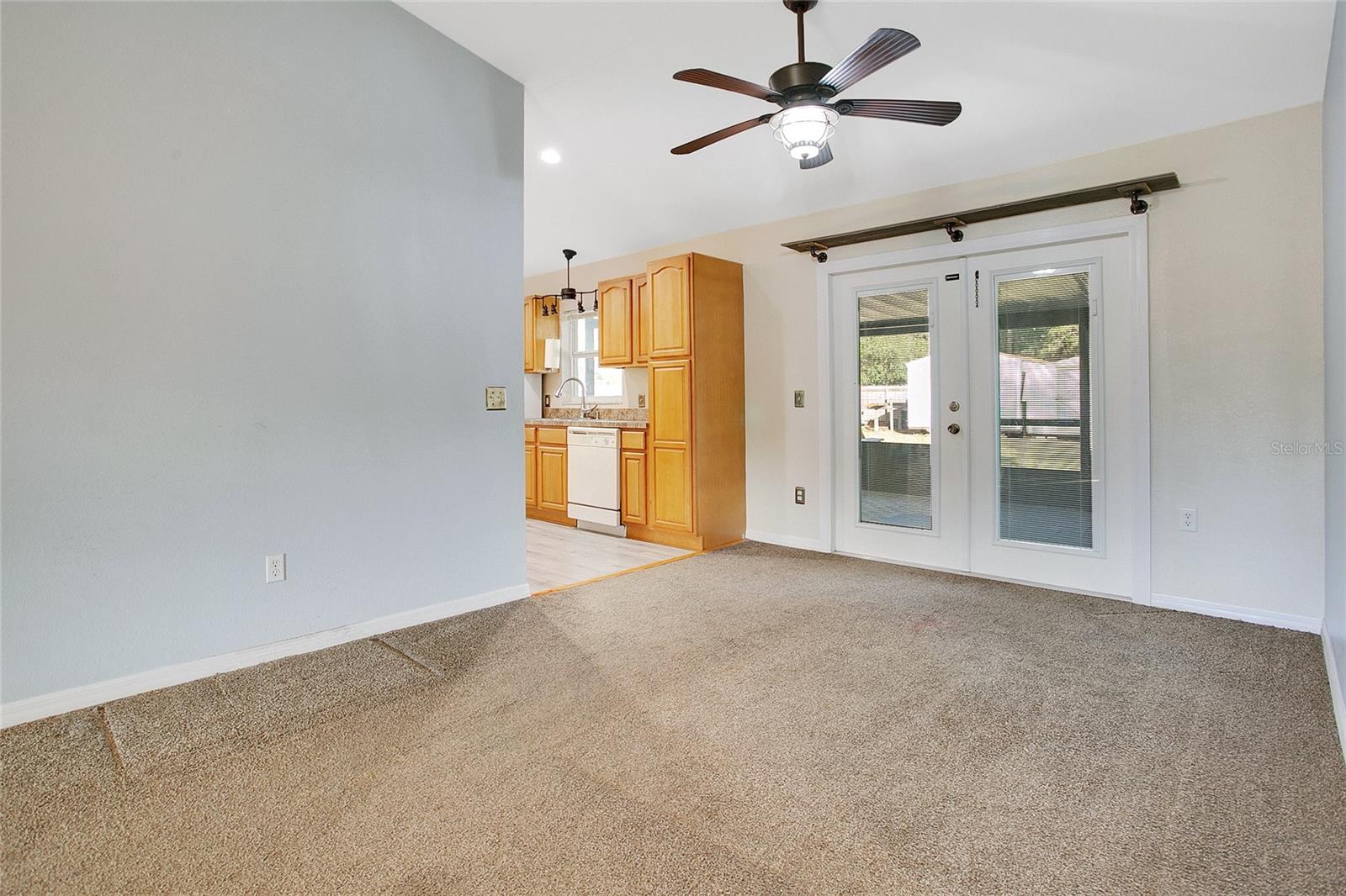 From the dining room you can enter the kitchen to the left or exit through the french doors that go to the screened-in back porch.