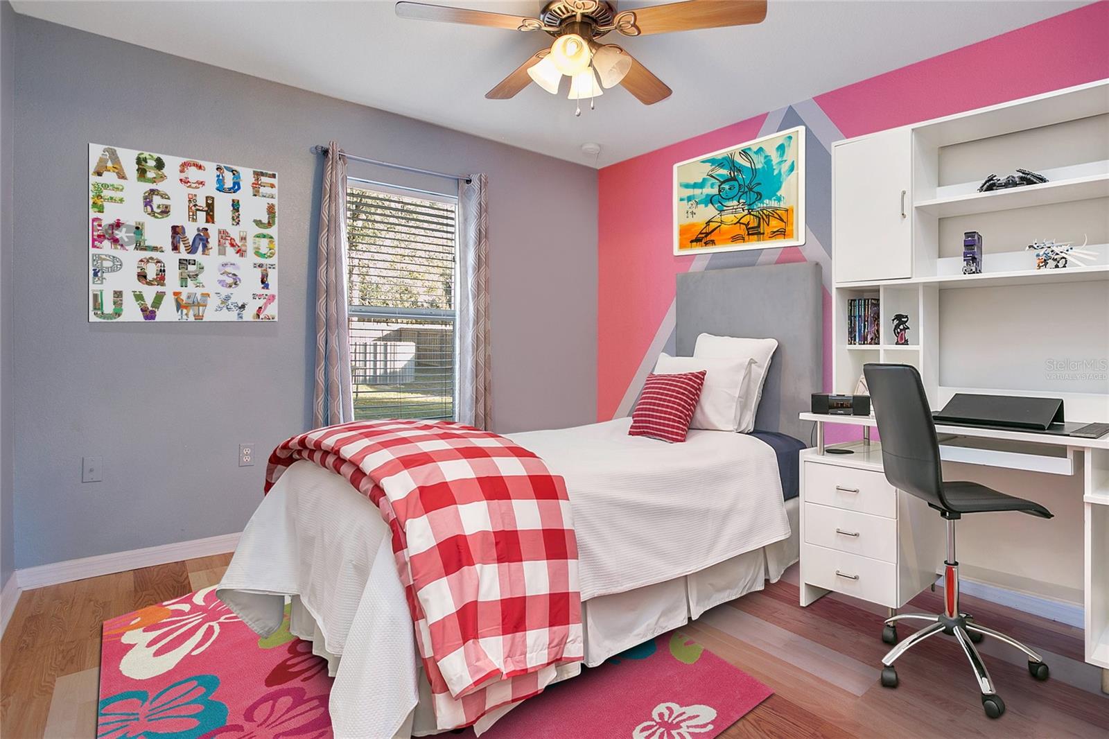 Bedroom 2 with accent wall details and a ceiling fan/light combo. Photo is virtually staged.