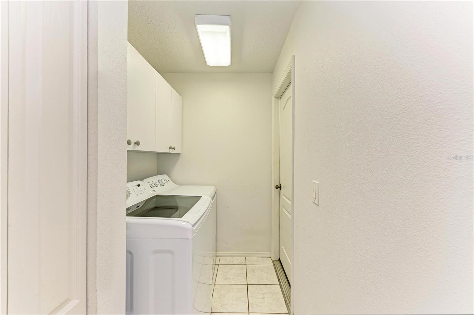 Laundry room with cabinets &amp; closet