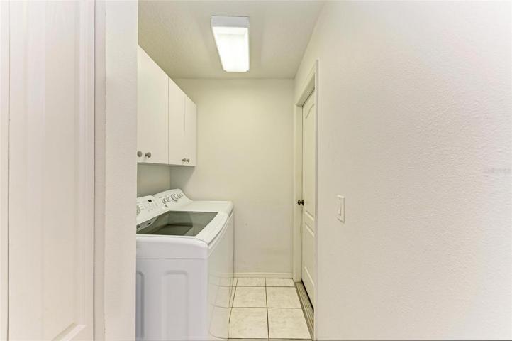 Laundry room with cabinets &amp; closet