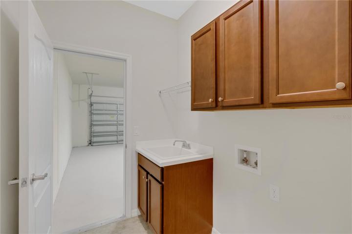 Inside laundry with cabinets for extra storage