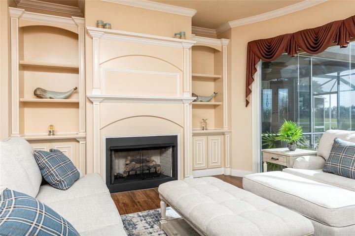Formal Living Room Featuring Trey Ceiling, Fireplace with Built in Shelving